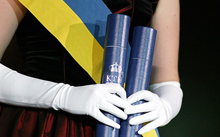 A woman with diplomas in her hands