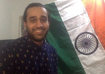 Photo: Mandar Josi in front of an Indian flag