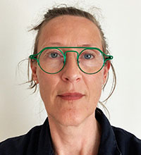 Portrait Photo: A woman wearing green glasses.