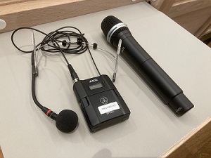 Photo of a fixed microphone with cable, and a portable wireless microphone.