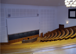 Lecture hall with successively raised, fixed seats.