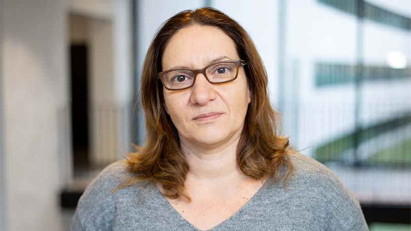 Woman with brown hair and glasses. 