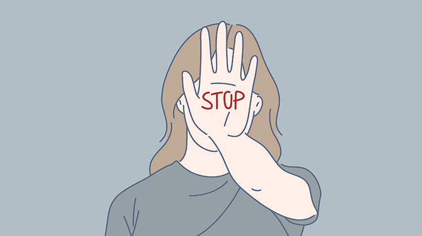 Woman holding up her hand with the word "stop"