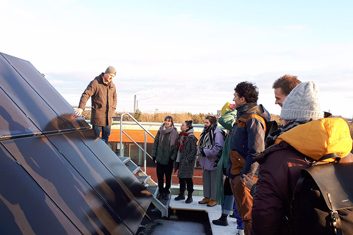 Tour on a roof top with solar panels.
