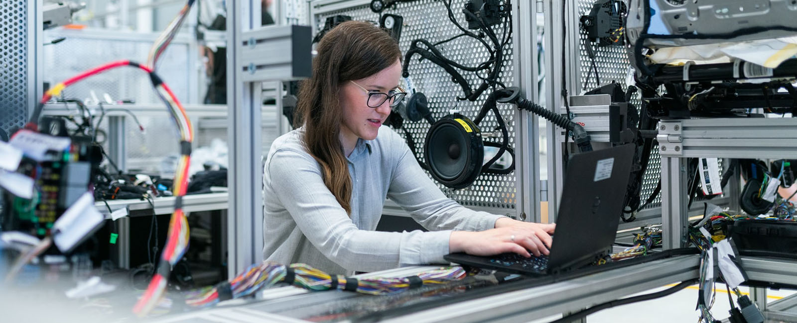 Woman with laptop in industrial surrounding