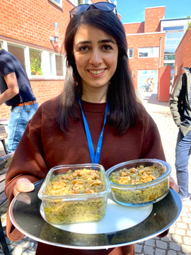 Woman holding two bowls with green mess.