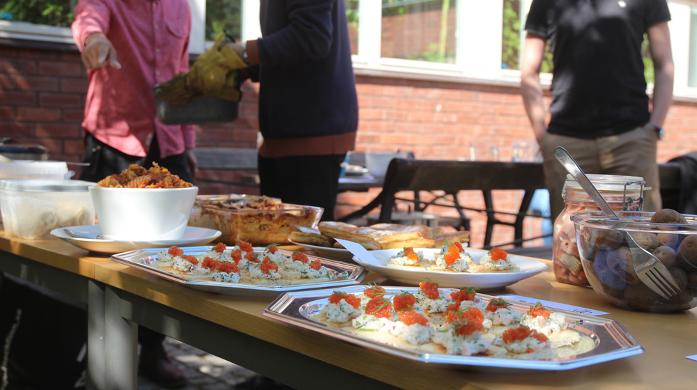 Buffet outdoor with people in the background preparing.