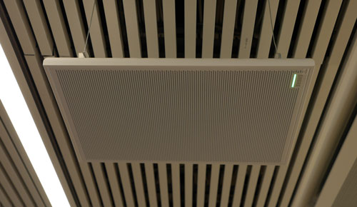 Square, flat microphone suspended from the ceiling