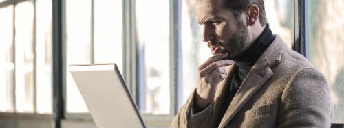 A man in front of a laptop