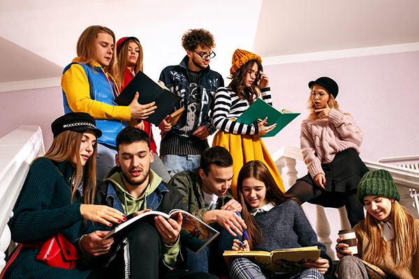A group of students looking up at eachother and books