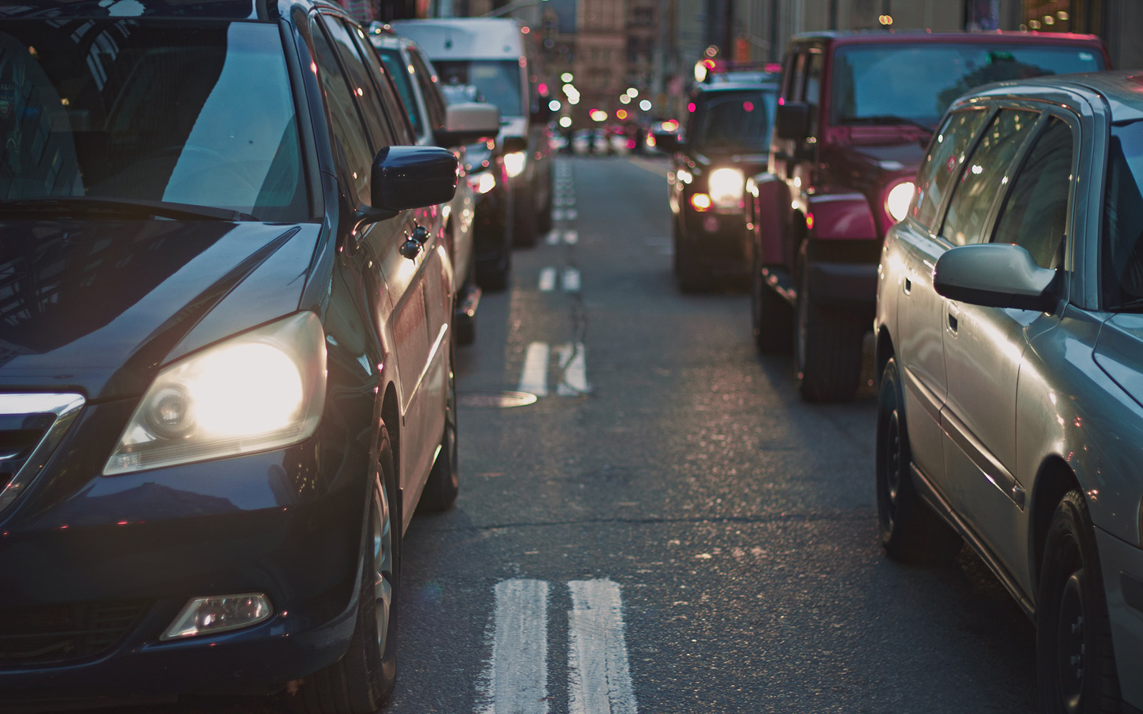 Photograph of cars on a busy city street. 