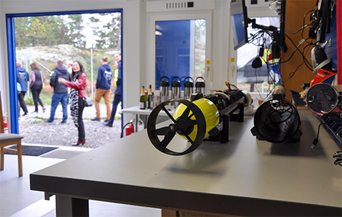 An AUV on a table with people in the background