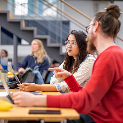 Two doctoral students participating in a workshop