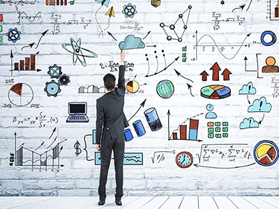 A man standing in front of a whiteboard full of data and calculations