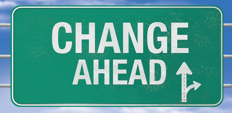 A green road sign with the text "change ahead"
