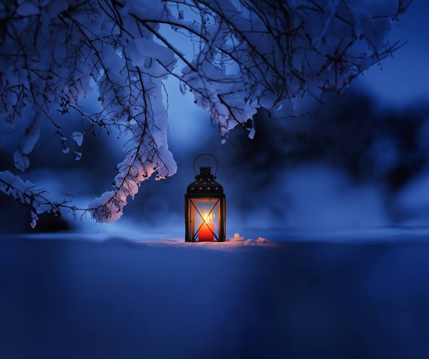 A candle holder in the snow.