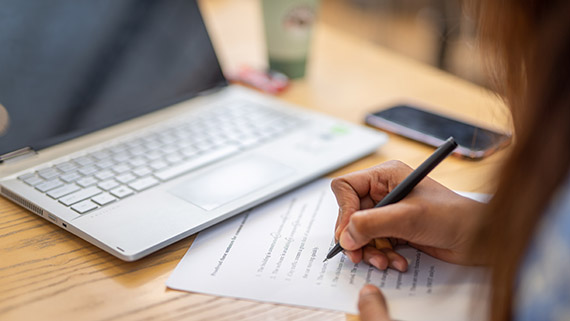 Student writing on a paper.