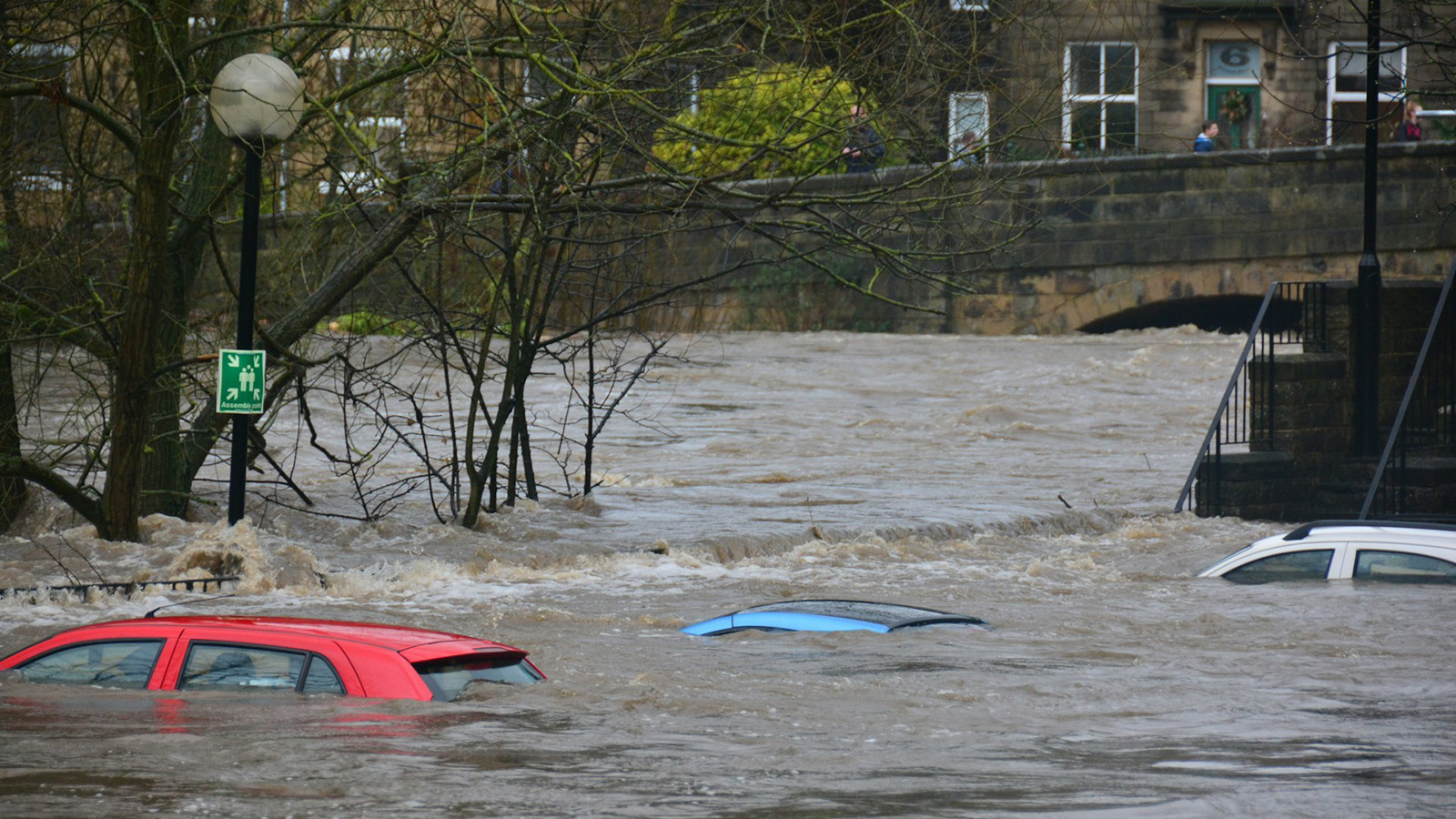 Cars almost wholly covered by a flood. 