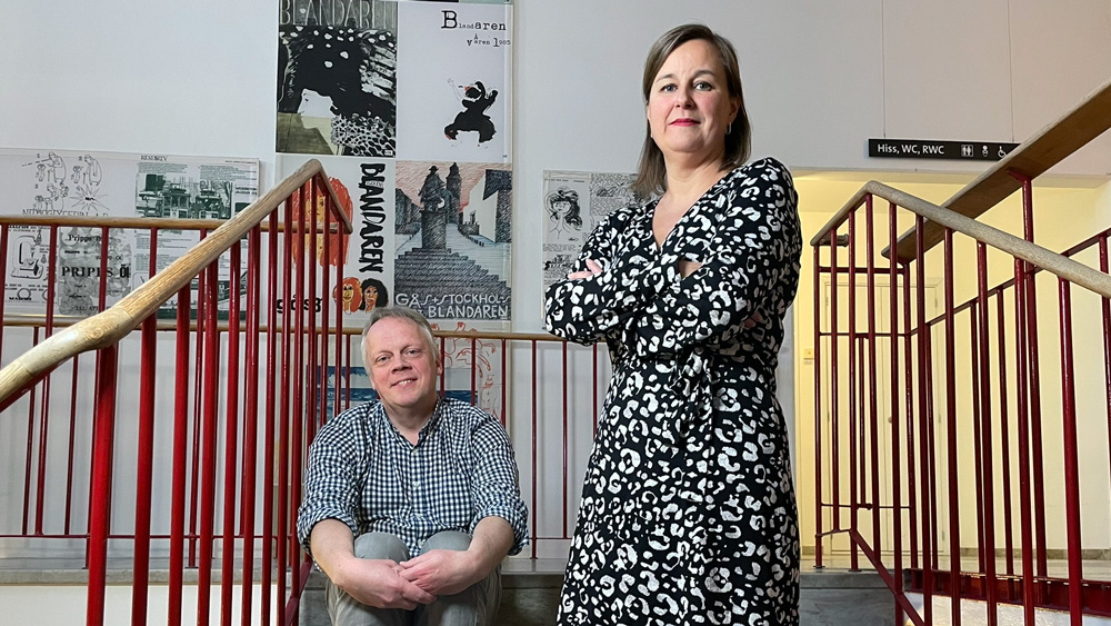 Woman standing and man sitting.