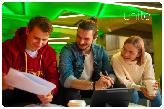 Three students with a laptop and some sheets of paper discussing