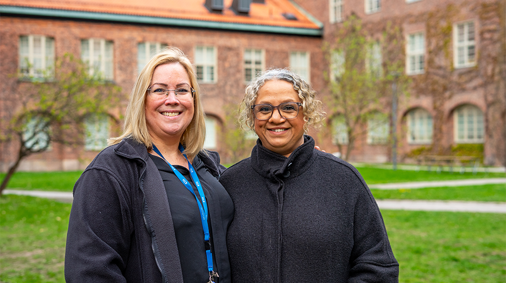 Two smiling women outdoors.
