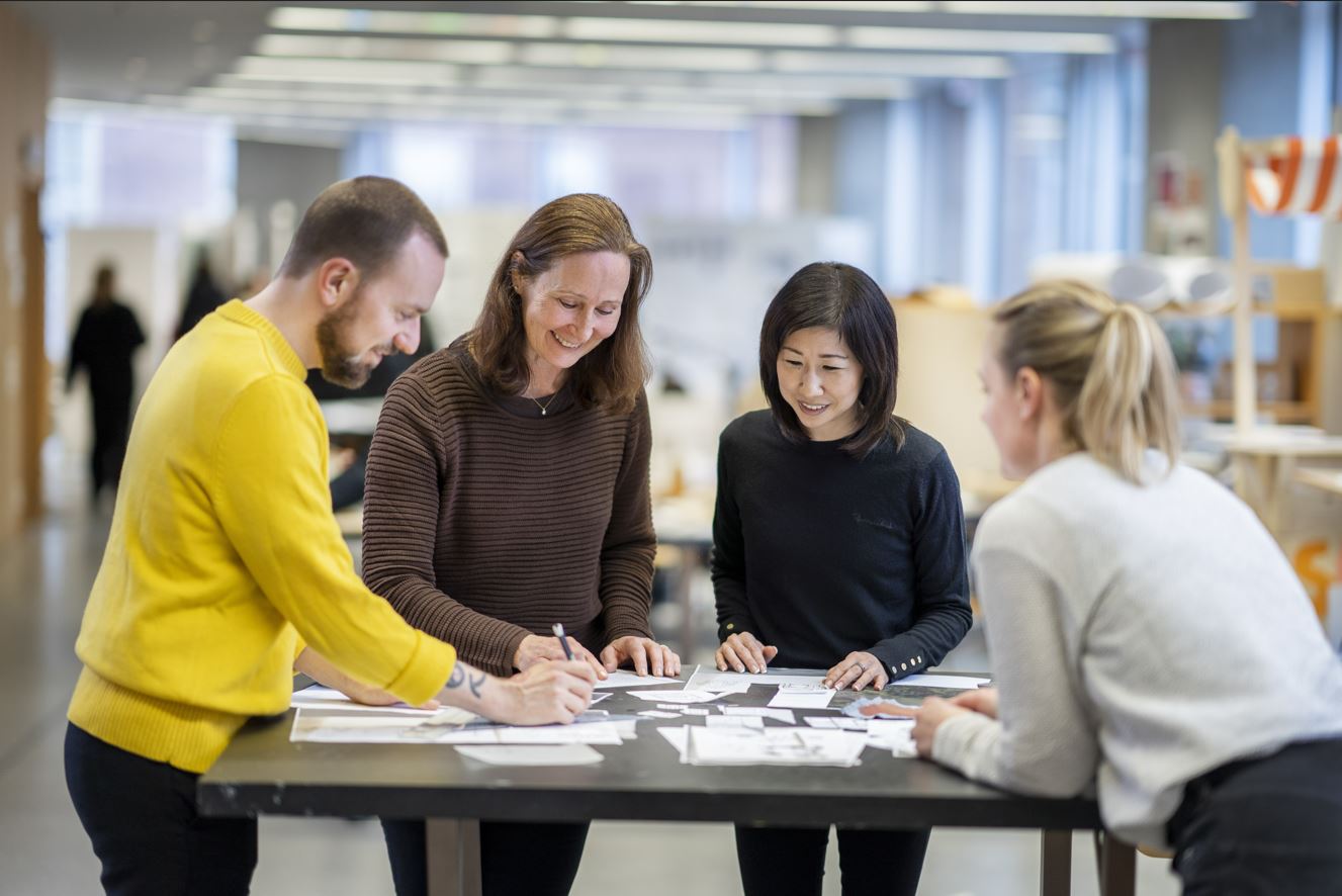 Colleagues standing working together at a table
