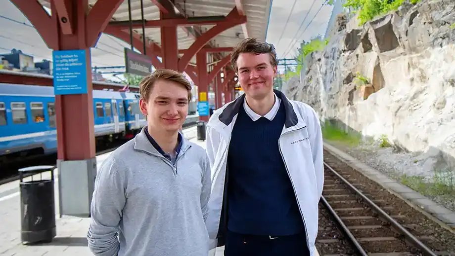 Two students on a train platform