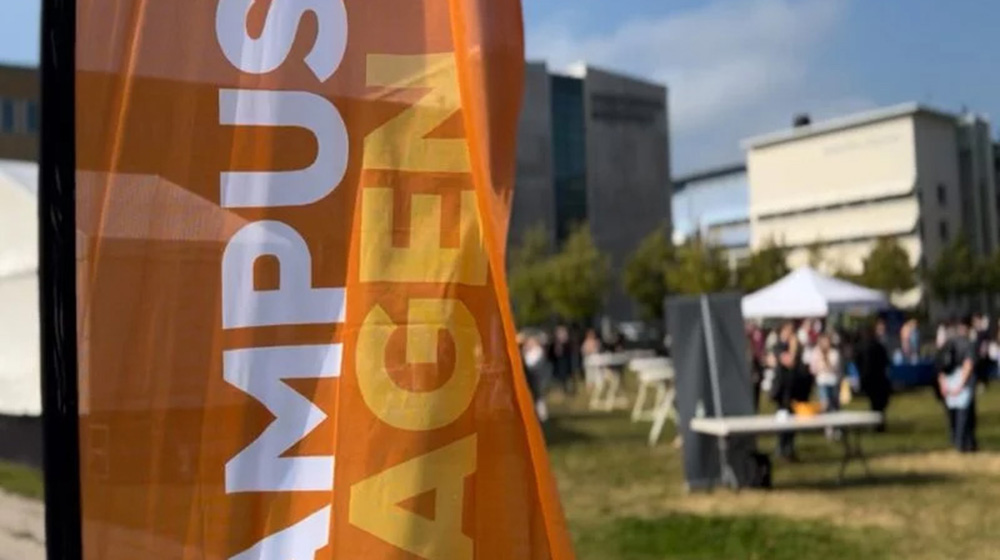 Photo from last years Campus Day, with logo and people in the background