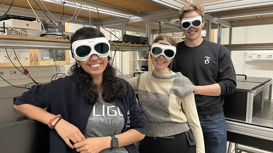 Three people with sunglasses in a lab