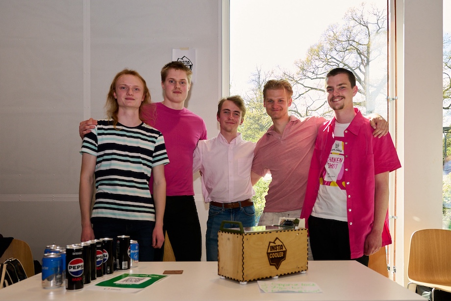 Photo: Five guys behind their robot.