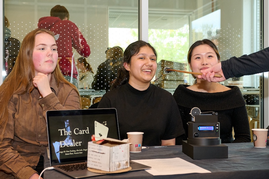 Photo: Three girls behind their robot.