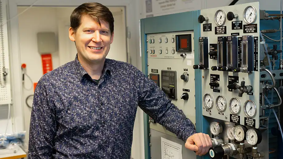 Man in front of lab machine.