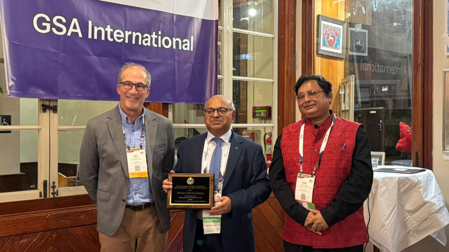 Picture of Prosun Bhattacharya (centre) receiving the award next to two colleagues.