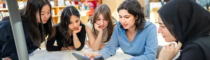 Students working as a group on a computer screen.