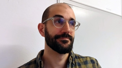 Photo: A man with glasses and beard.