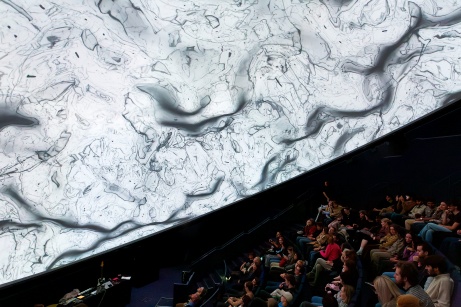 Audience watching film in a dome theater