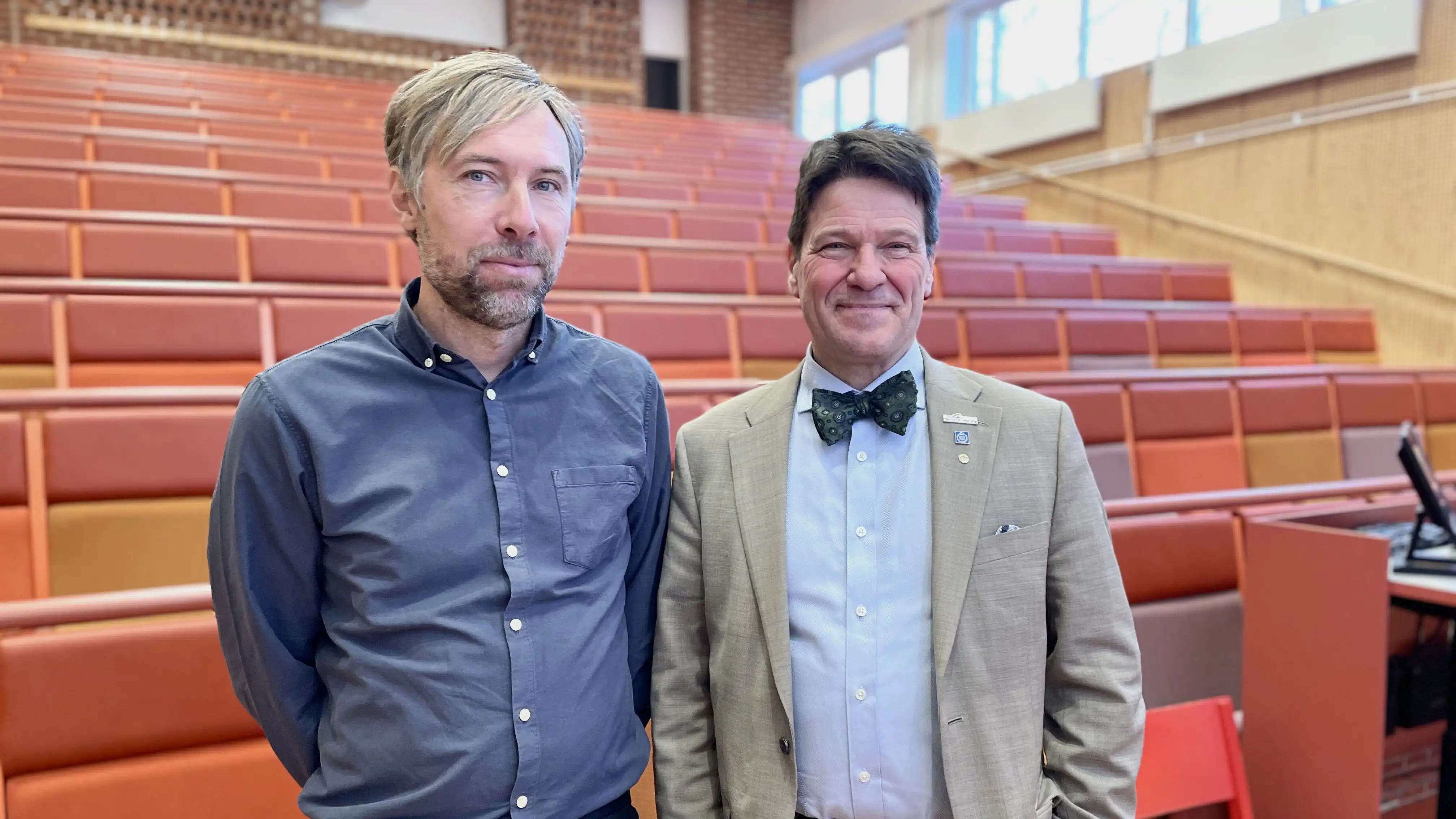 Two men in a lecture hall