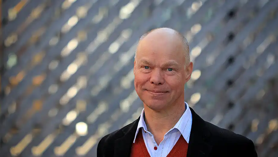 Bald man in a jacket.