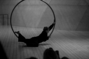 Black and white photo of Alva rolling on the cyr wheel