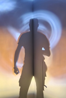 Shadow casted on a walk surrounded by blue, orange and yellow