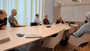 People around a table in a group room.