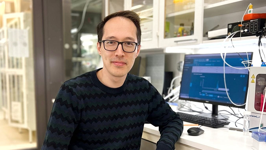 Man standing in front of bush. 