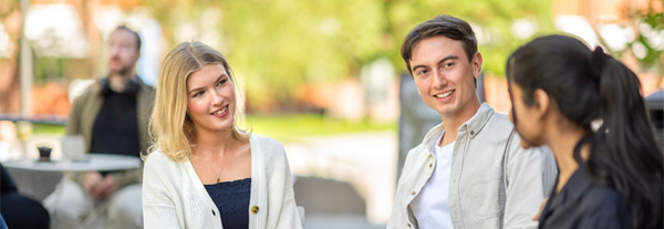 Students sitting talking outside