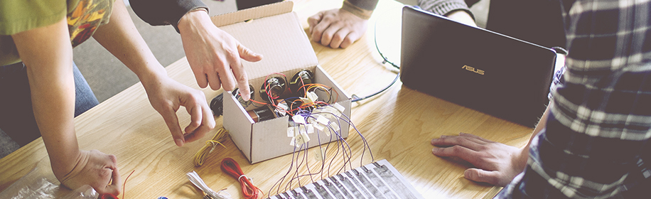 Hands that are working with a tech-project