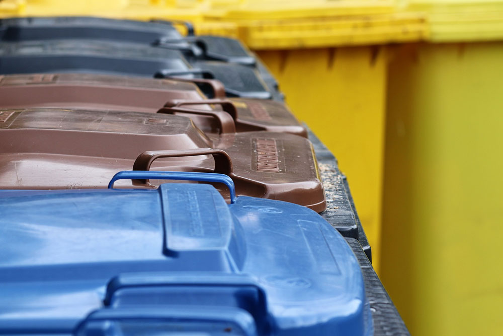 Garbage bins in different colours.