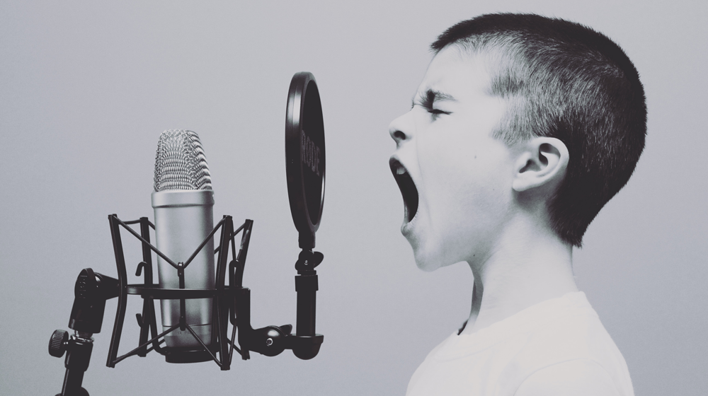 Person screaming in a microphone.